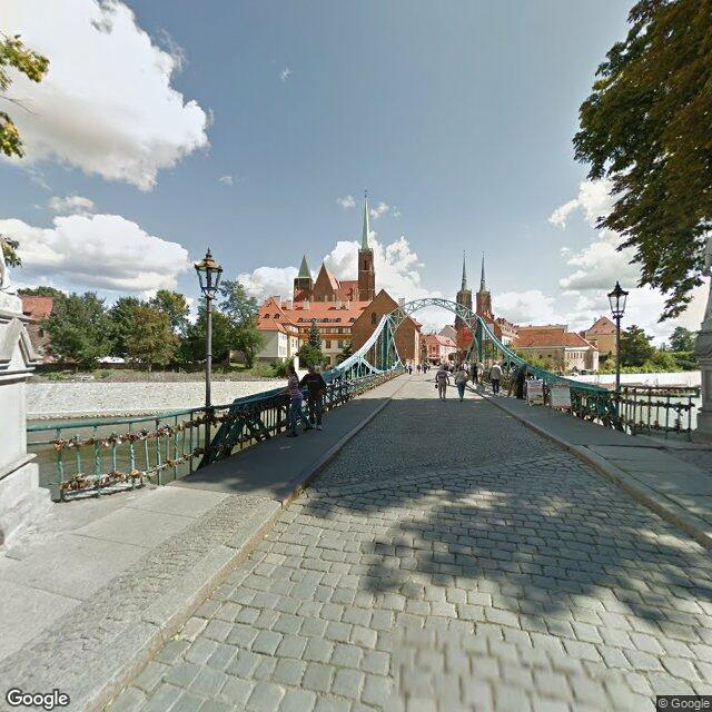 Most Tumski, the bridge onto the island; the cathedral's twin spires over the trees