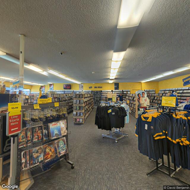 The frame I kept: the aisles of the last Blockbuster. Street-level imagery, June 2023.