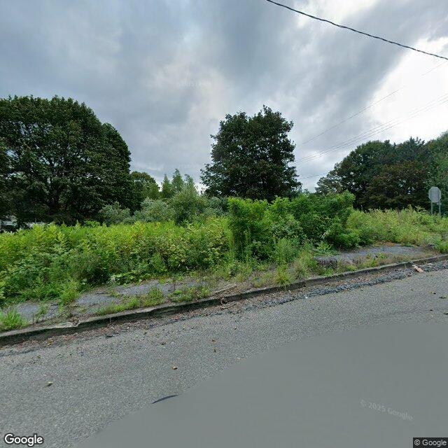 The frame I kept: a street with its houses gone. Street-level imagery, August 2025.